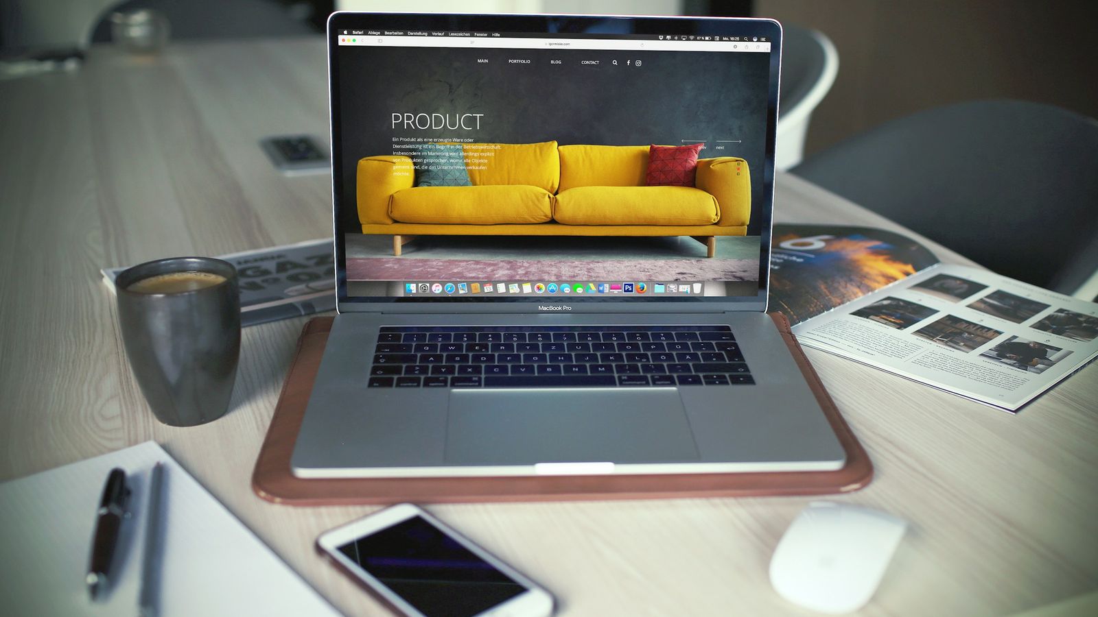 Laptop on a desk showing an online store product page for a yellow sofa.